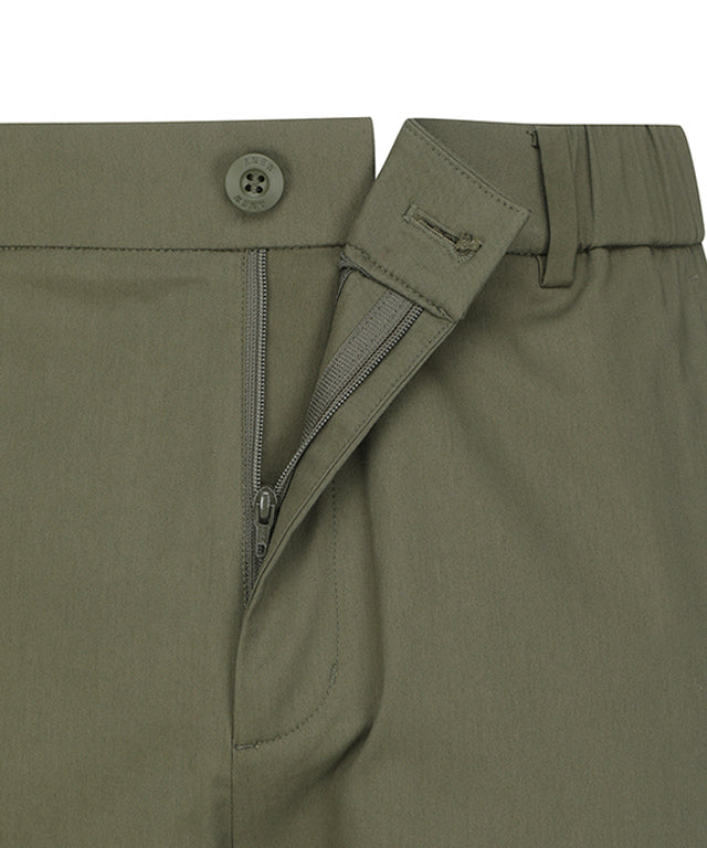 ANEW Golf Men Loose Fit Selvage Roll-Up Long Pants displayed on a hanger, showcasing the relaxed fit and stylish roll-up design.